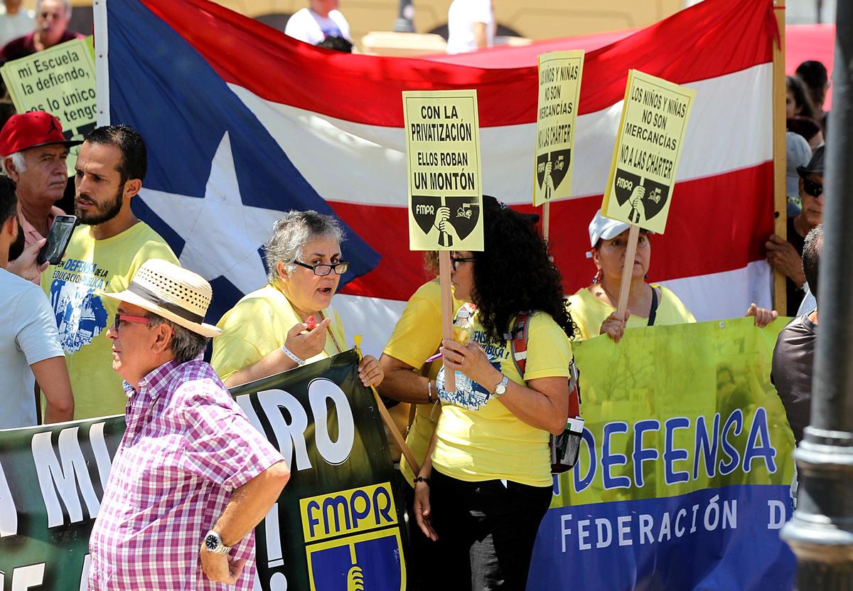 A group of teachers with the Puerto Rican teachers union (Federación de Maestros de Puerto Rico) protests school closures at Plaza Colón in San Juan on Aug. 15, 2018.