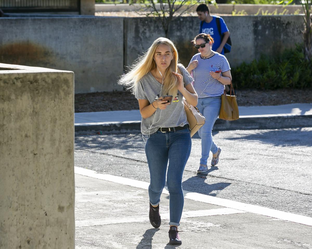 Commuters arrive at the Miami Dade College Kendall Campus bus stop on Thursday, Nov. 7, 2019. Miami-Dade County officials are thinking of redesigning the bus system, a process that would require choosing between boosting ridership or preserving existing stops.