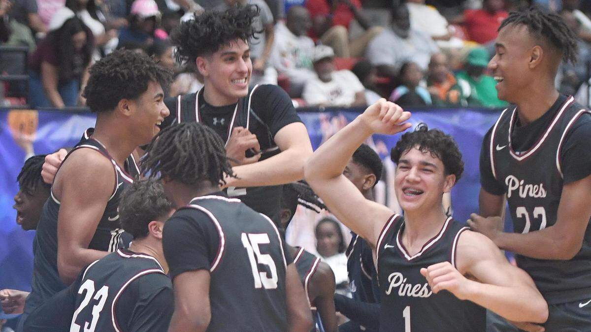 Pembroke Pines Charter players jump on each other after beating Edgewater in the Class 6A final during the Florida High School State Championships at the RP Funding Center in Lakeland, Fl on Friday March 8, 2024. Pembroke Pines Charter defeated Edgewater 59-54 to win the Class 6A State Title. Scott Wheeler | Photo