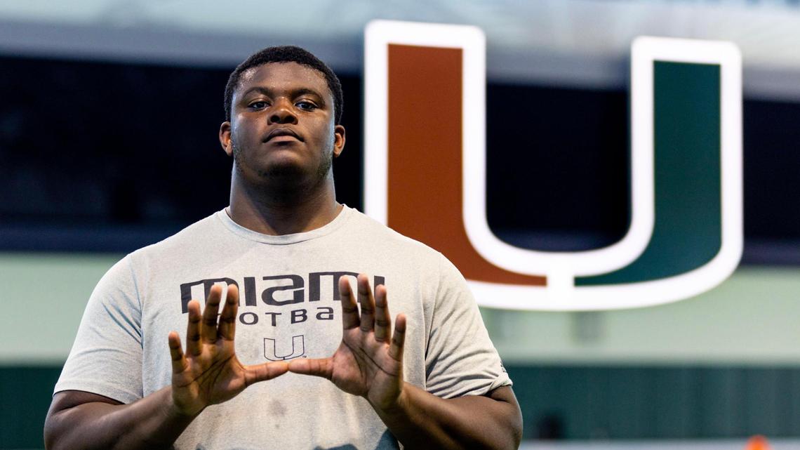Miami Hurricanes offensive lineman Javion Cohen throws up the U for a portrait after spring football practice at the University of Miami’s Greentree Practice Field in Coral Gables, Florida, on Tuesday, March 28, 2023.