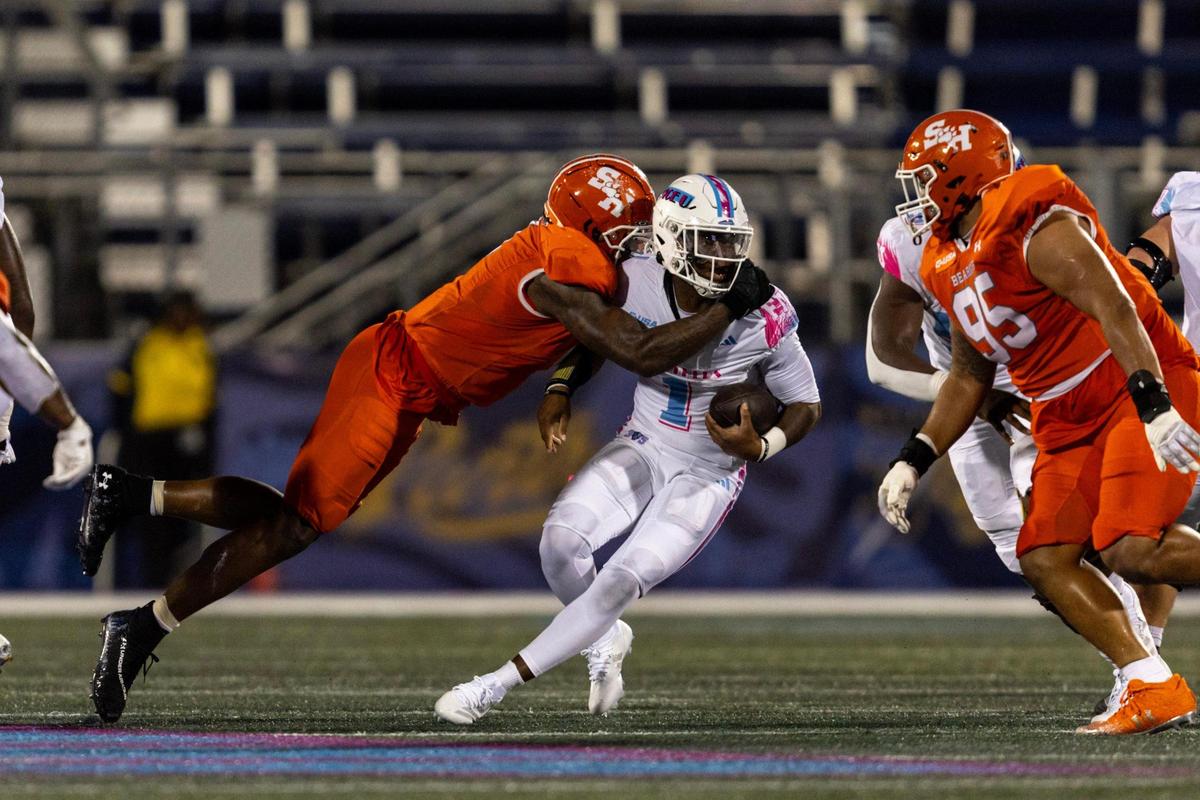 Florida International University Panthers quarterback Amari Jones (2) is sacked by Sam Houston State Bearkats defensive lineman Chris Murray (0) during the first half of a NCAA Conference USA football game on Tuesday, October 22, 2024, in Miami, Fla.