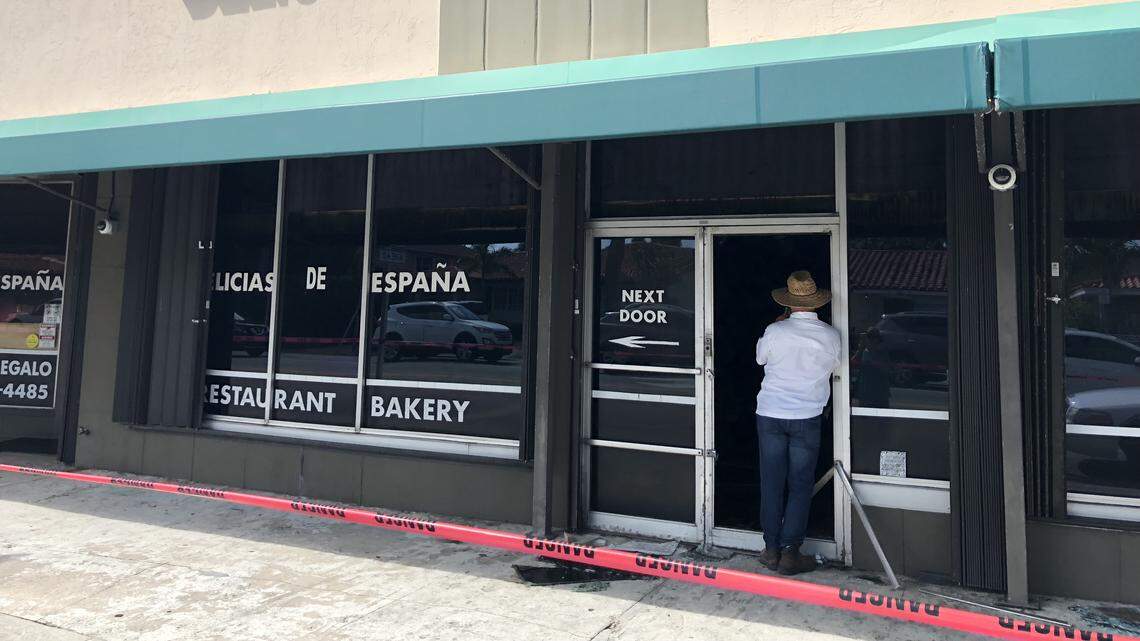 A building manager inspects Delicias de España after a fire gutted the beloved Spanish restaurant on Oct. 16.