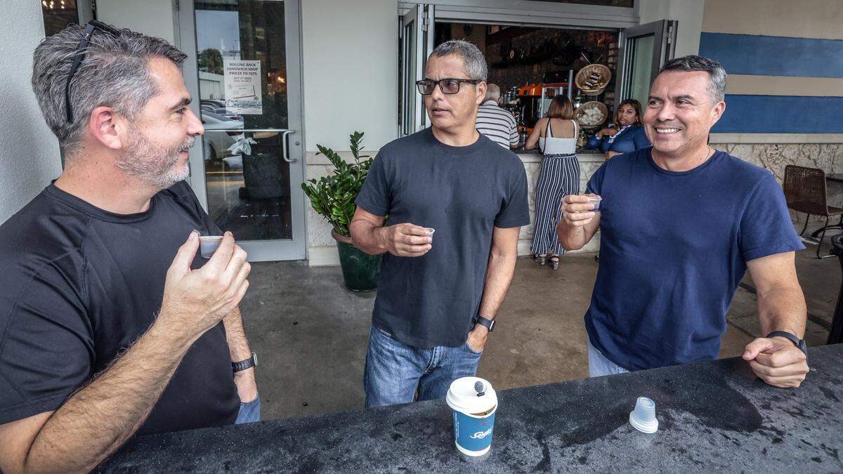 Jose Villafuerte, Ricky Guevara and Juan Silva share a cafesito outside la ventanita at Sergio's restaurant in Kendall. The local restaurant chain is celebrating it's 50th Anniversary in Miami, Florida, on Wednesday, September 24, 2025. 