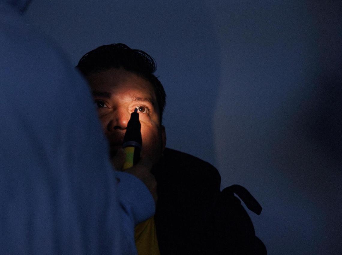Jose Villatoro receives a free eye exam from Dr. Almas Khan, who helped start the free optometry at the clinic in 2016, inside the UHI CommunityCare Clinic on Monday, Dec. 16, 2024, in Opa-locka, Fla.
