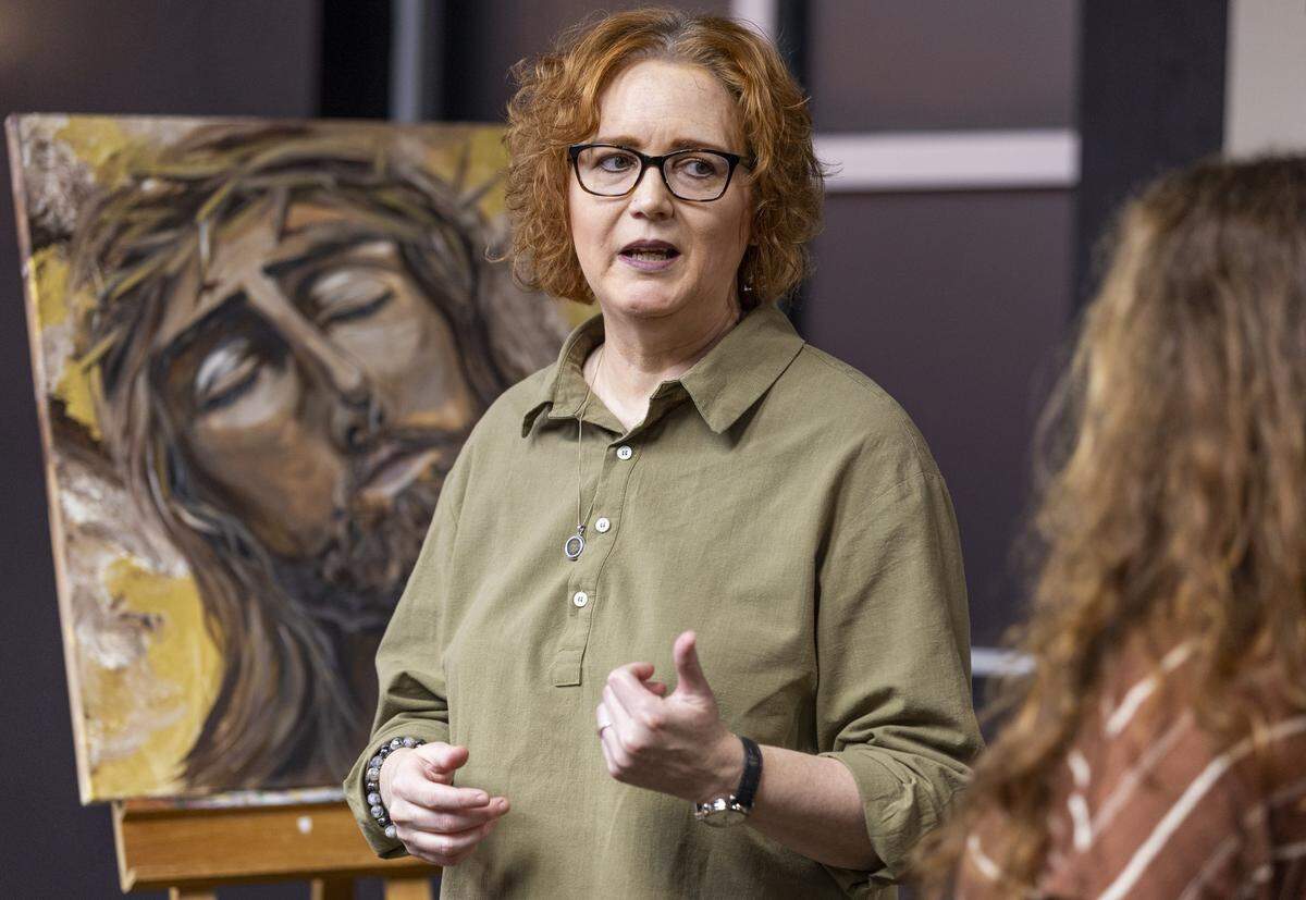 Pastor Jennifer LeClaire talks with church member, Vanessa Angelini, at Awakening House of Prayer in Davie. LeClaire says that an artificial intelligence–generated video was made to look and sound like her and was used to ask a follower for money.