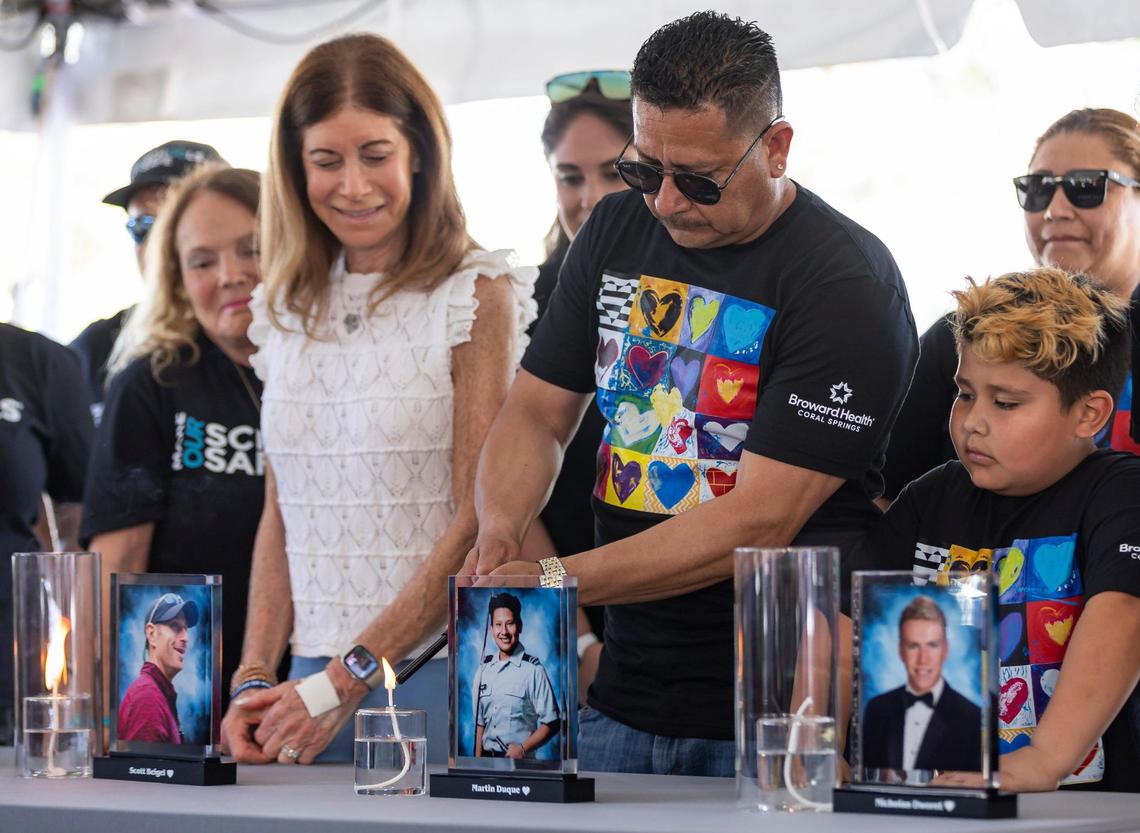 Martin Duque, the father of Martin Duque Jr., lights a candle in his honor during the ‘Forever in Our Hearts’ commemoration event outside of the Eagles’ Haven Wellness Center on Friday, Feb. 14, 2025, in Coral Springs, Fla. The event aims to honor the 17 lives lost during the Marjory Stoneman Douglas High School shooting in 2018 and their families.