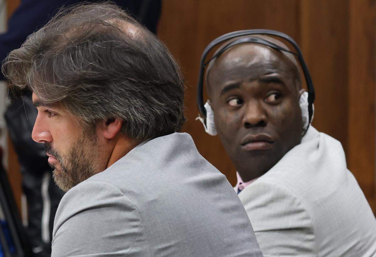 Adolfo Gil, left, sits with his client Yosvanis “Chocolate MC” Sierra Hernandez as prosecutors presented their witness during the first day of his trial for solicitation of first-degree murder as prosecutors presented their witness in Courtroom 7-4 at the Richard E. Gerstein Justice Building on Wednesday, November 12, 2025, in Miami, Florida. 