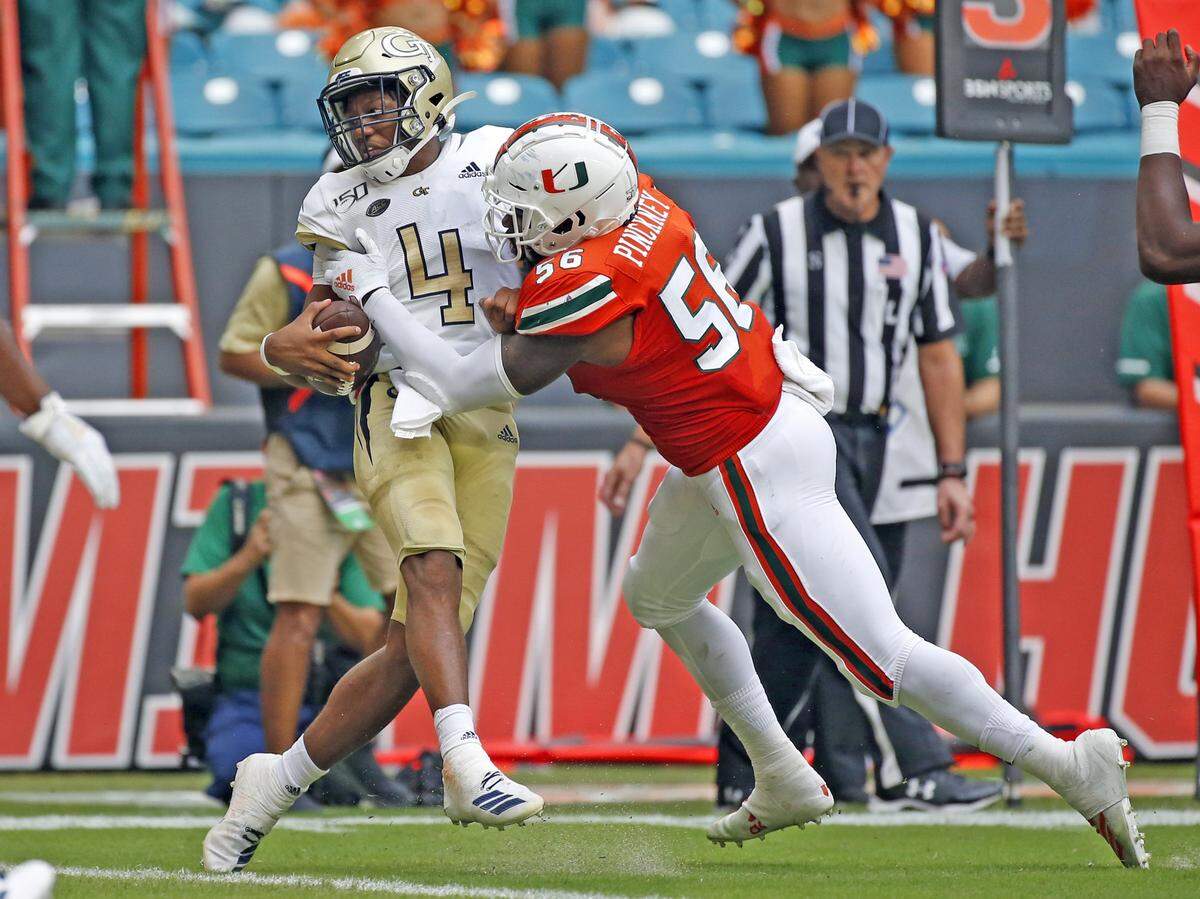 Miami Hurricanes linebacker Michael Pinckney (56) sacks Georgia Tech Yellow Jackets quarterback James Graham (4) in the first half as the University of Miami hosts the Georgia Tech Yellow Jackets at Hard Rock Stadium in Miami Gardens on Saturday, October 19, 2019.