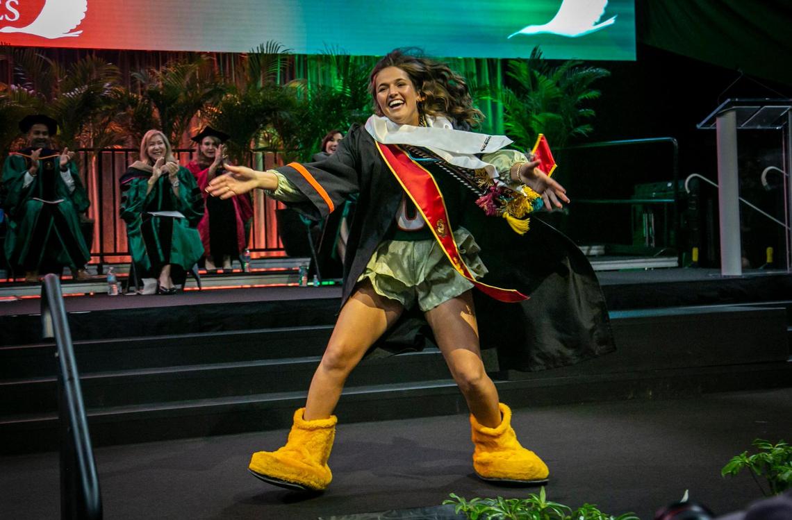 Madison Clinger, the first female Sebastian, the school mascot, leads graduates and guests on one last C-A-N-E-S cheer at the University of Miami graduation ceremony Friday morning in Coral Gables.