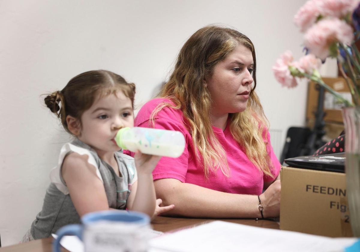 Executive Director of Tree of Life Parenting Gloria Martinez, right, and her daughter Elliana, 2, work in Coral Gables on Tuesday, May 24, 2022 at Tree of Life Parenting inside the Wesley Hispanic United Methodist Church. Tree of Life has been collecting donations of formula from parents for other parents.