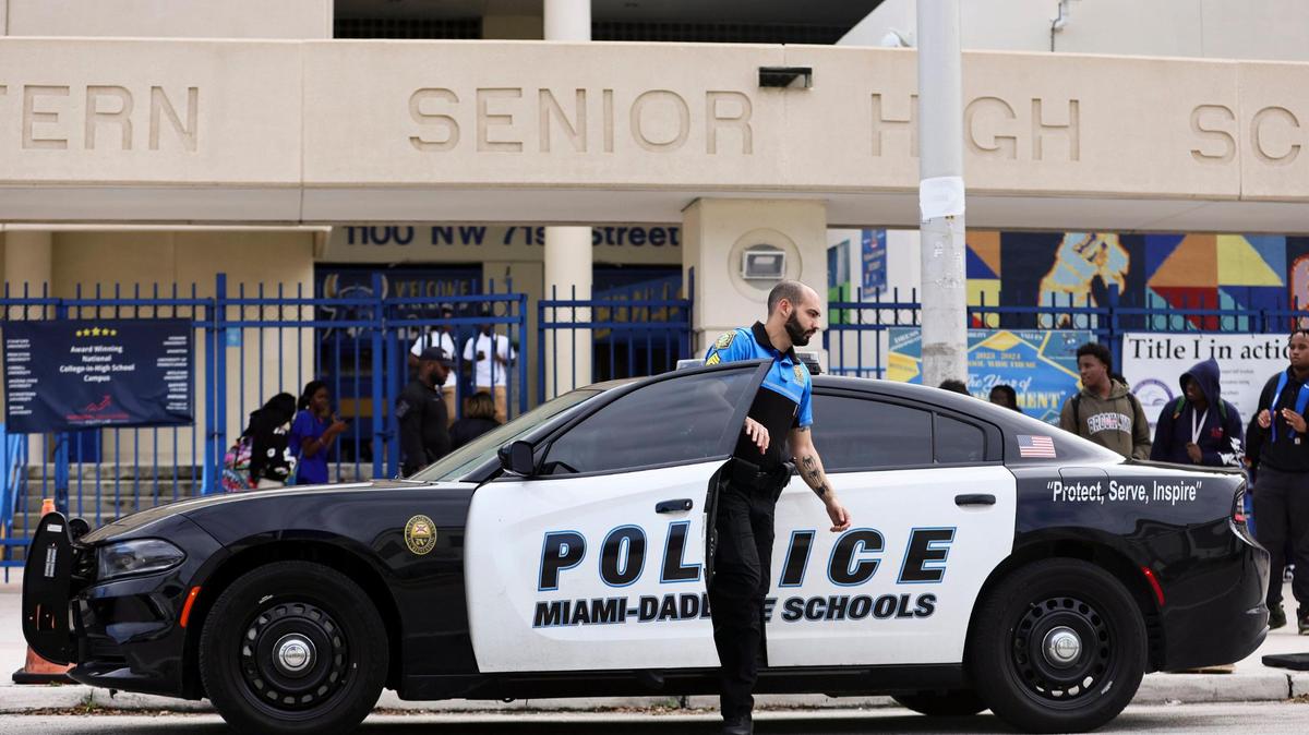 A Miami-Dade Schools police officer arrives at Miami Northwestern Senior High in Miami, Florida, Friday, January 12, 2024. Miami-Dade Public Schools increased its police presence at the school the day after a student was shot on campus following a boys basketball game.