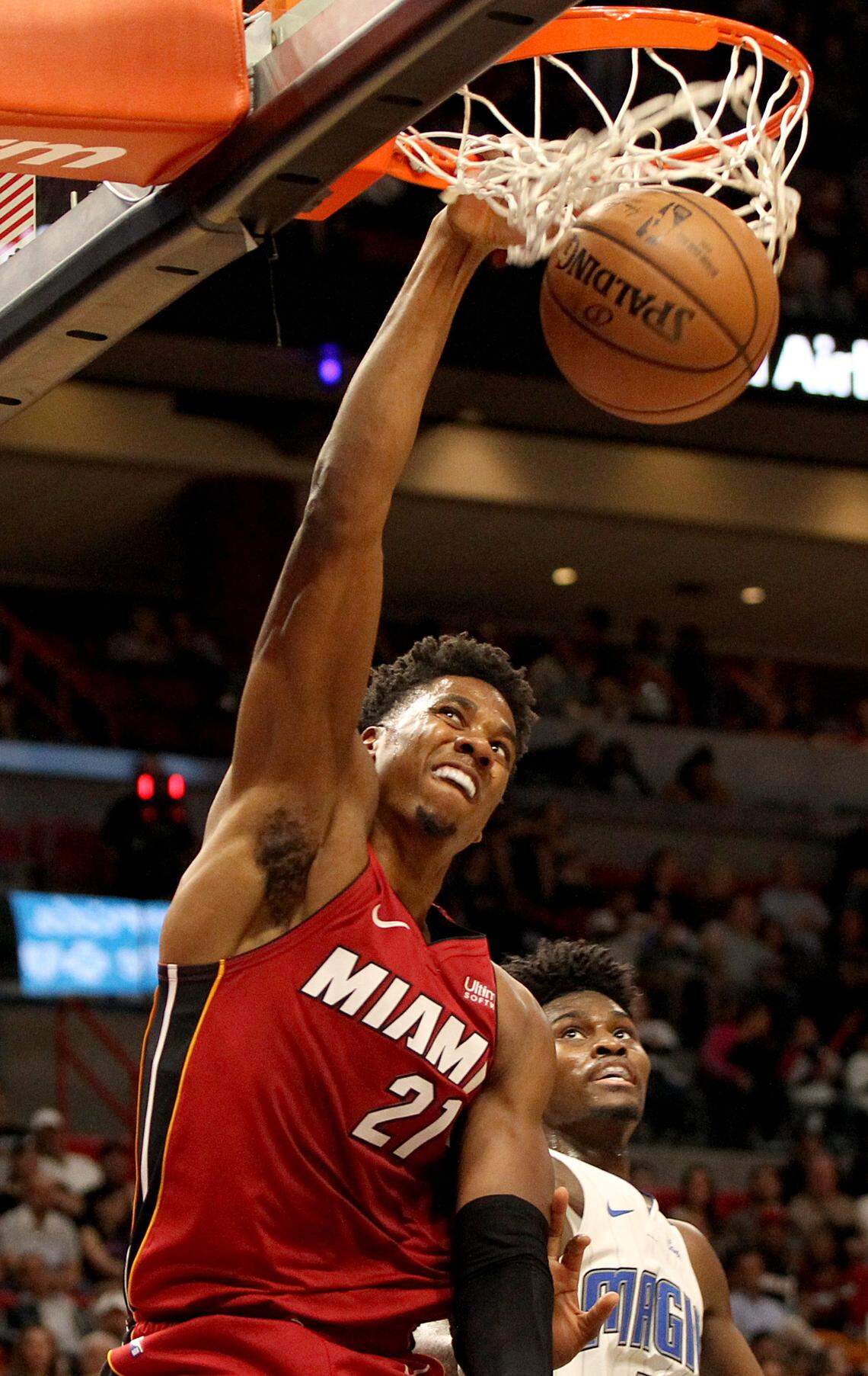 Heat center Hassan Whiteside dunks against Magic’s forward Jonathan Issac, in the second quarter of the Miami Heat vs Orlando Magic at AmericanAirlines Arena in Miami on Tuesday, December 04, 2018.