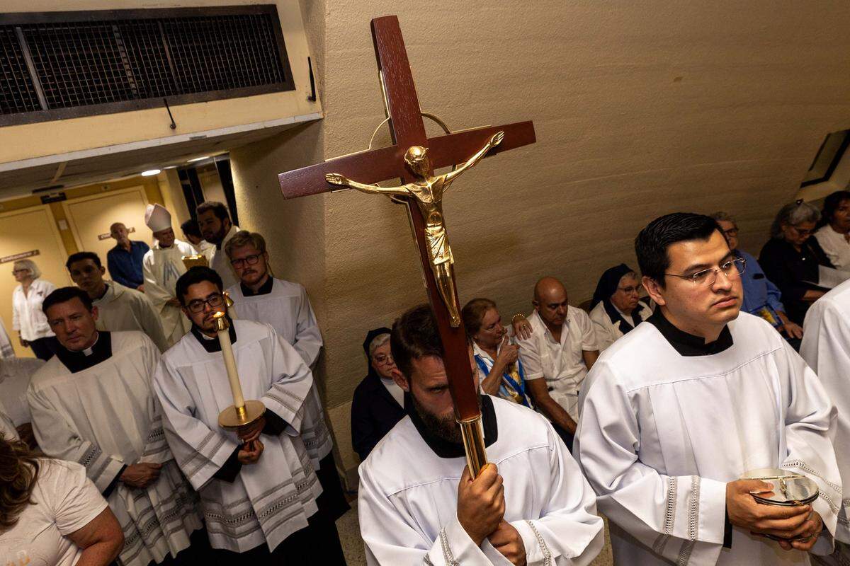 Clergy members stand at the ready for mass during the annual celebration of the feast day of Cuba's patroness, Our Lady of Charity, at Ermita de la Caridad, also known as National Shrine of Our Lady of Charity, on Monday, September 8, 2025, in Coconut Grove, Fla.