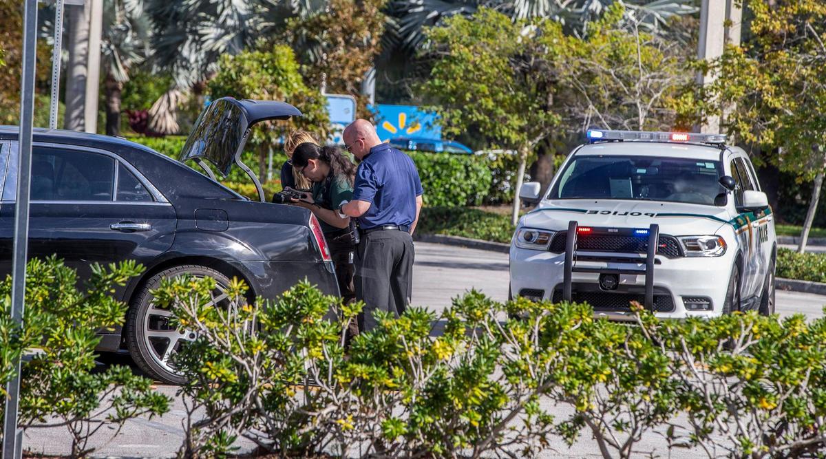 Miami-Date crime scene investigators take [pictures as they check a vehicle fitting the description of one used in a robbery to an individual after leaving a TD Bank on Tuesday night, February 01. Police were called by security personnel at the TD Bank located at 9201 W Flagler St in Miami, after noticing the suspicious car park next to the bank, resulting in the arrest of two men occupying the car. Detectives are investigating to see if they are involved in the mentioned robbery, on February 02, 2022,