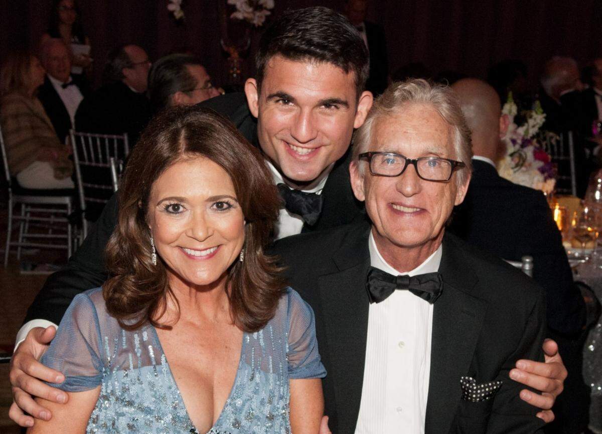Maria and Don Browne get a hug from their son, Christopher, at a Women of Tomorrow Gala at the Mandarin Oriental Hotel in Miami in 2015.