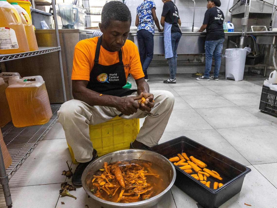 A man peels carrots at the World Central kitchen in Les Cayes, where thousands of hot meals are prepared daily to feed victims of the August 14, 2021, earthquake.