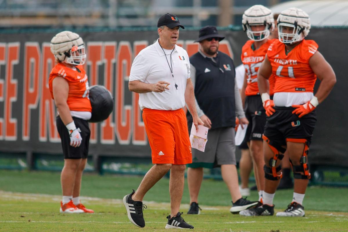 Miami Hurricanes head coach Mario Cristobal talks to his players during spring practice at the University of Miami in Coral Gables, Florida, Saturday, March 4, 2023.