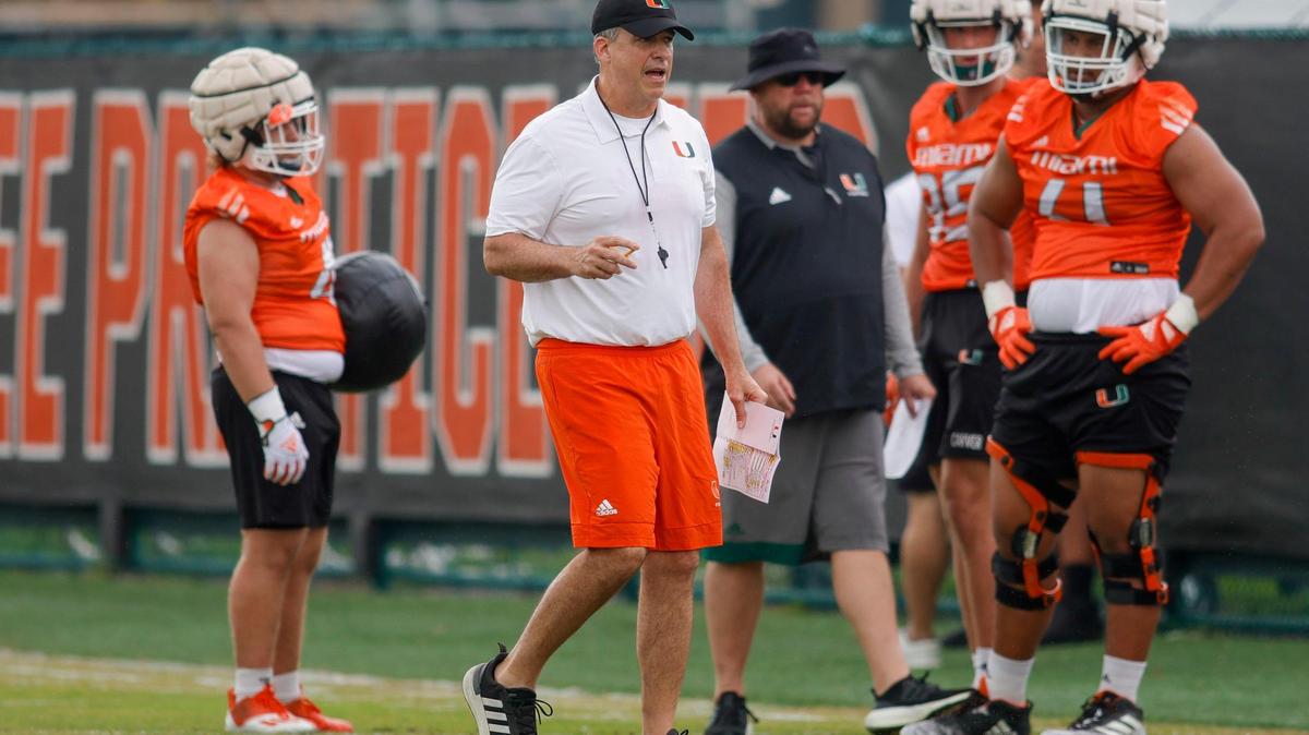 Miami Hurricanes head coach Mario Cristobal talks to his players during spring practice at the University of Miami in Coral Gables, Florida, Saturday, March 4, 2023.
