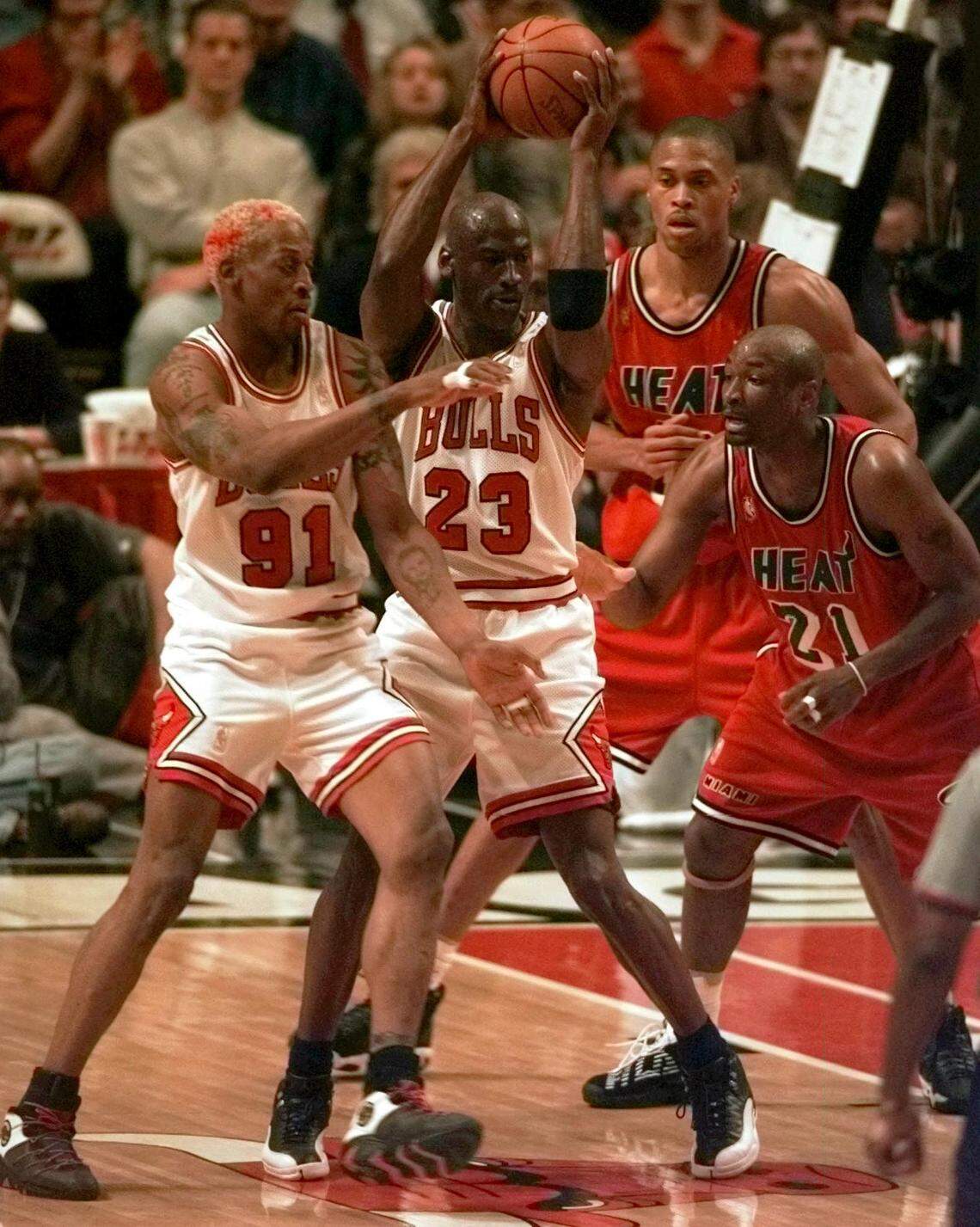 FILE PHOTO - The Chicago Bulls’ Michael Jordan (23) looks to pass off as he gets caught between teammate Dennis Rodman (91) and the Miami Heat’s Voshon Lenard (21) during the first quarter of Game 5 in the Eastern Conference Finals Wednesday, May 28, 1997, in Chicago. This was not the game where the undermanned Heat squad beat the Bulls.