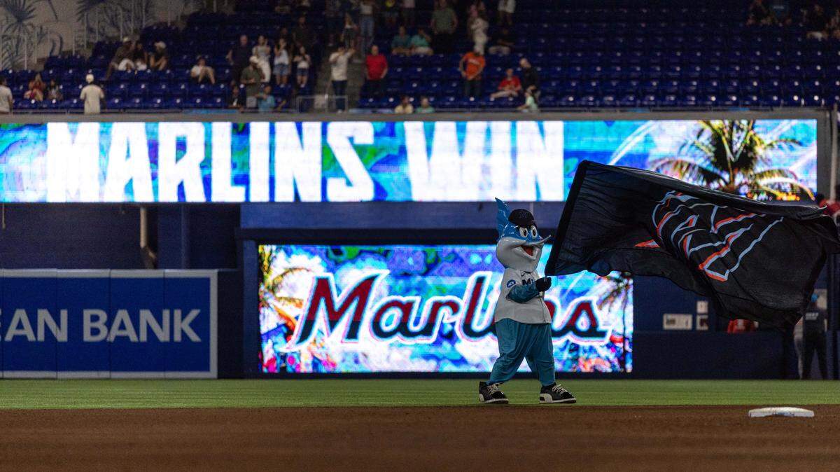 Miami Marlins mascot Billy the Marlin waves a flag after the Fish defeated the St. Louis Cardinals 6-2 after nine innings of an MLB game at loanDepot park on Wednesday, August 20, 2025, in Miami, Fla.