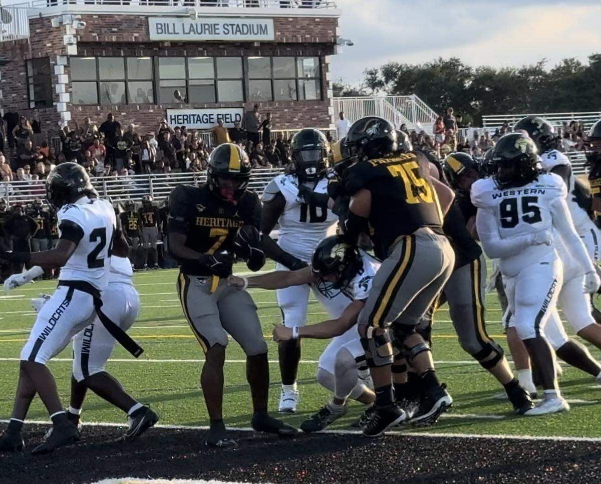 American Heritage running back Byron Louis (7) powers into the end zone for one of his two rushing touchdowns in Friday night’s win over Western at American Heritage.