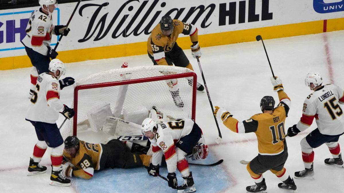 Vegas Golden Knights center Nicolas Roy (10) and right wing Keegan Kolesar (55) celebrate after left wing William Carrier (28) scored against the Florida Panthers during the third period of an NHL hockey game Thursday, Jan. 12, 2023, in Las Vegas. (AP Photo/John Locher)