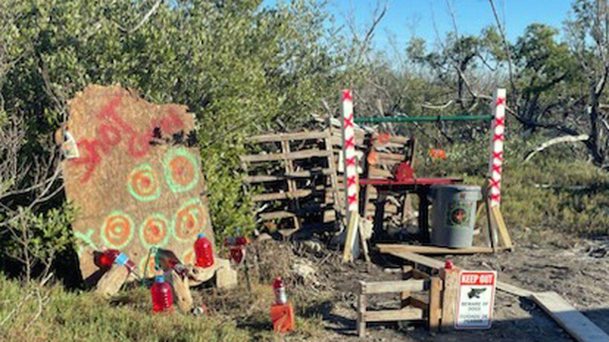 A collection of makeshift targets are placed in a yard at Kings Cove Road in Little Torch Key Thursday, Jan. 9, 2025. The Monroe County Sheriff’s Office said three people shooting at the targets hit a nearby home.