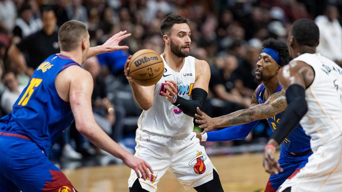 Miami Heat guard Max Strus (31) looks to pass as Denver Nuggets center Nikola Jokić (15) and guard Kentavious Caldwell-Pope (5) defend during the third quarter of an NBA game at the Miami-Dade Arena on Monday, Feb. 13, 2023, in downtown Miami, Fla.
