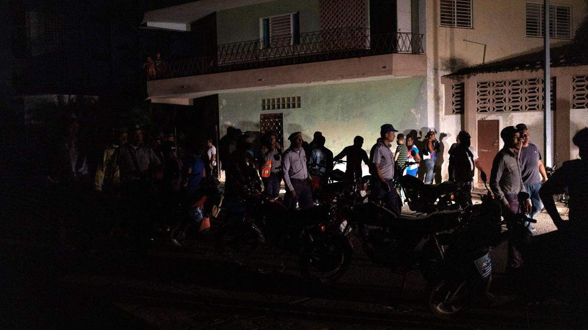 National police patrol among protesters asking for the restoration of electrical services after four days of power outages caused by Hurricane Ian, in Havana, Cuba, Friday, Sept. 30, 2022. (AP Photo/Ramon Espinosa)