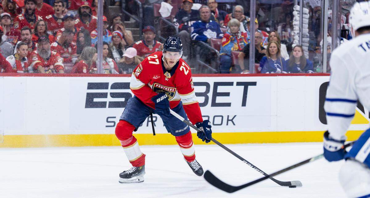 Florida Panthers center Eetu Luostarinen (27) looks to pass the puck as Toronto Maple Leafs center John Tavares (91) defends in the first period of Game 6 of a second-round Stanley Cup playoffs series at the Amerant Bank Arena on Friday, May 16, 2025, in Sunrise, Fla.