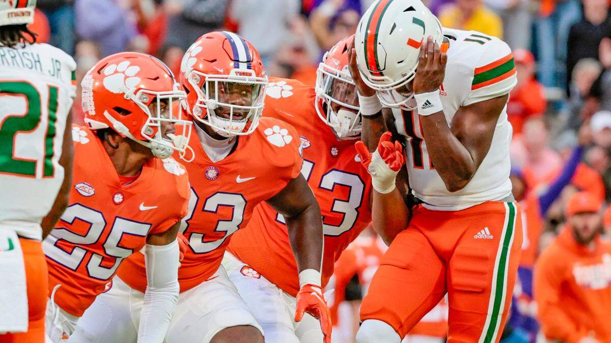 Miami Hurricanes quarterback Jacurri Brown (11) reacts after Clemson Tigers safety Jalyn Phillips (25) intercepts the ball in the first quarter at Frank Howard Field at Clemson Memorial Stadium in Clemson, South Carolina on Saturday, November 19, 2022.