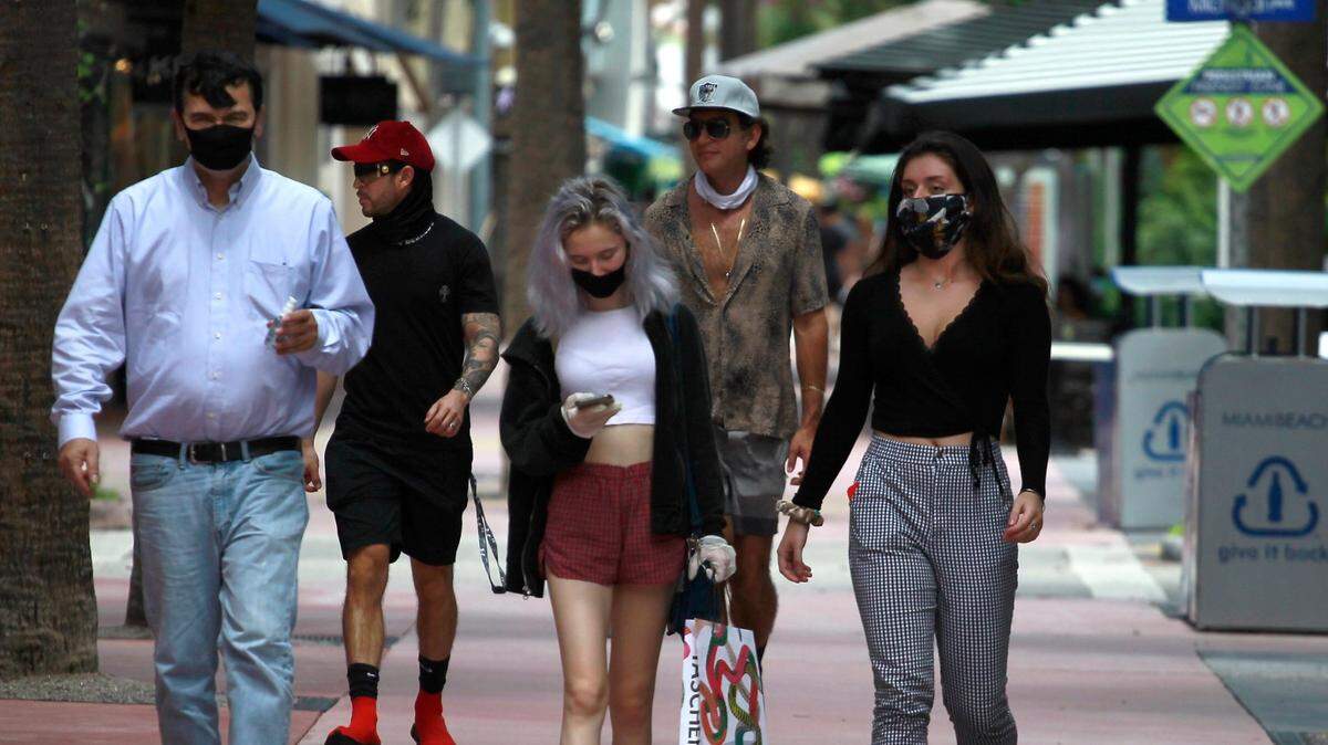 Tourists and shoppers walk down Lincoln Road in Miami Beach on Sunday, July 12, 2020.