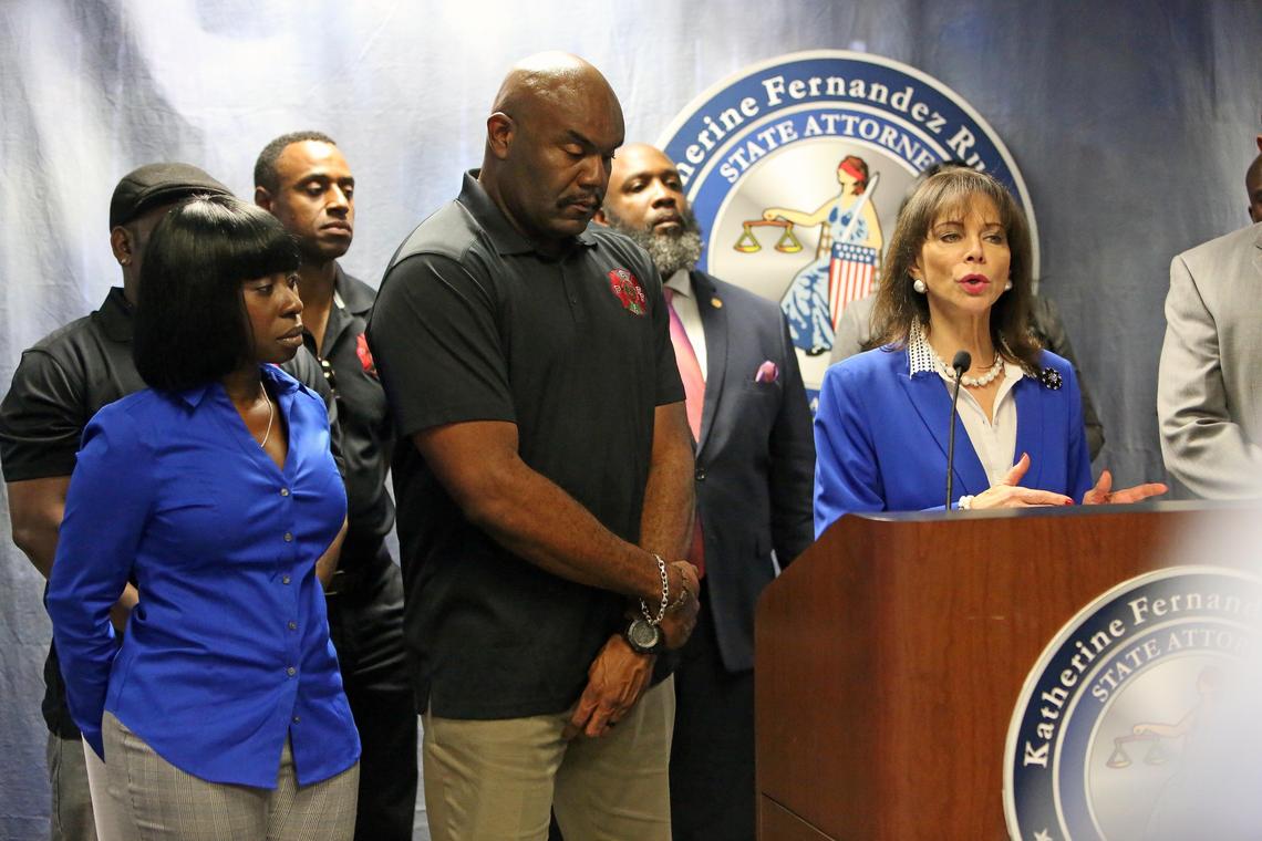 Firefighter Lt. Robert S. Webster and wife Vickey Webster during a press conference Feb. 12, 2019, with Katherine Fernandez Rundle as charges were announced against four firefighters accused of defacing photos of Webster’s family at Station 12.
