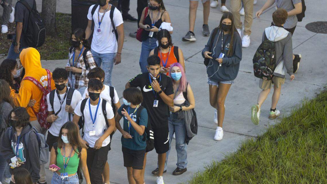 Broward Cypress Bay High School students enter campus as they returned back to school under a school board mask mandate on Wednesday, Aug. 18.