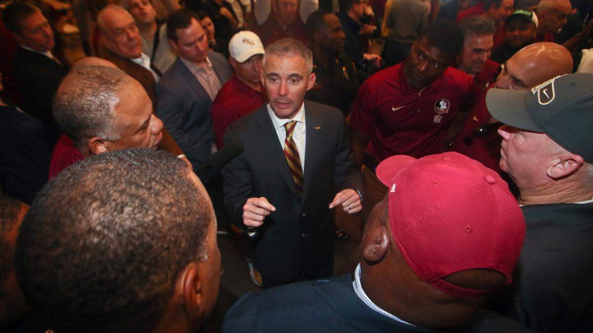 Florida State head football coach Mike Norvell talks to football staffers after a press conference Sunday, Dec. 8, 2019, in Tallahassee, Fla. Norvell is Florida State’s new coach, taking over a Seminoles program that has struggled while he was helping to build Memphis into a Group of Five power.