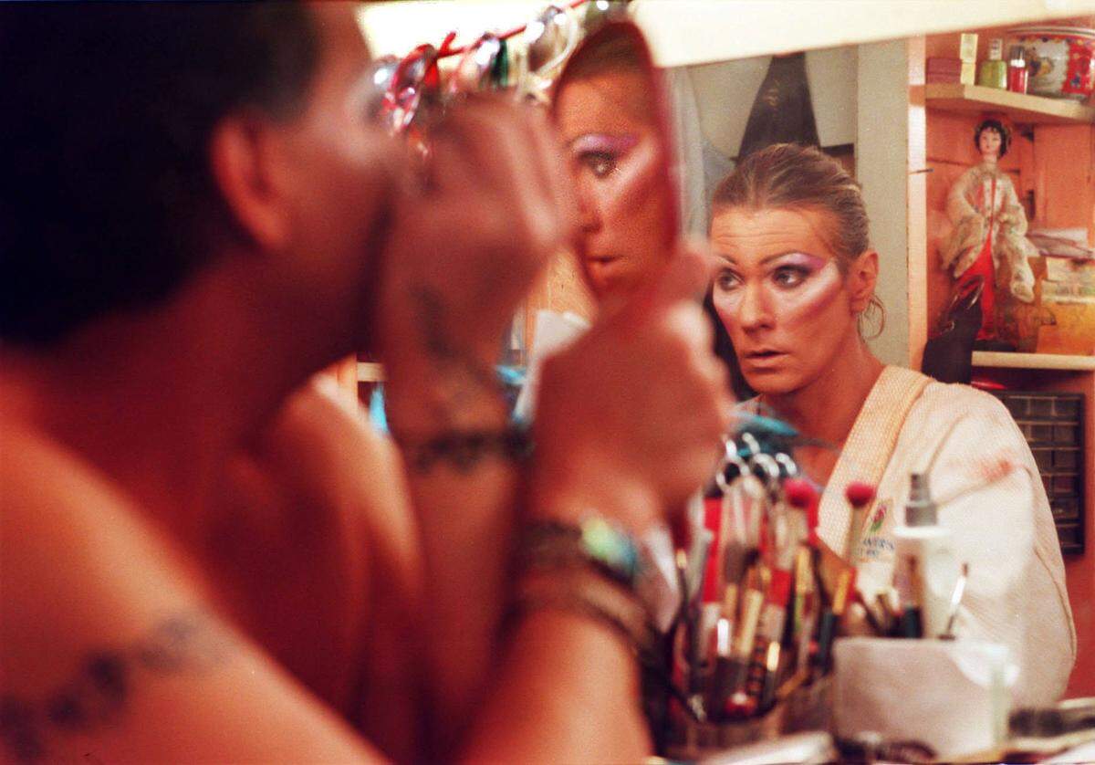 Milla, left, applies her makeup, while Destiny, right, looks over her hair at at 801 Bourbon Bar, located on Duval Street, in order to prepare for a show in 2001.