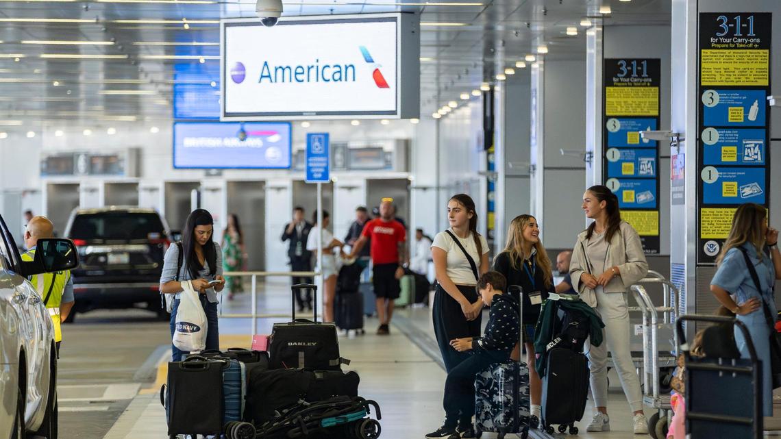 Travelers are seen at the American Airlines departure area at inside Miami International Airport on Monday, May 1, 2023.