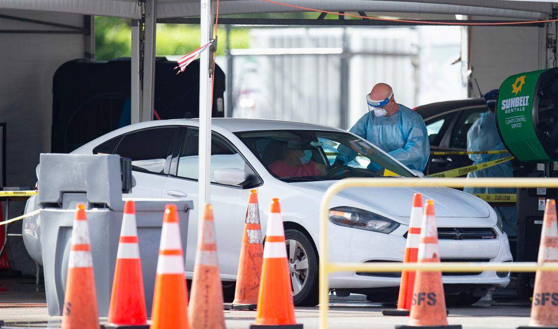 Citizens is being tested by a healthcare workers at the COVID-19 drive-thru testing center at Hard Rock Stadium in Miami Gardens as the coronavirus pandemic continues on Sunday, July 19, 2020.