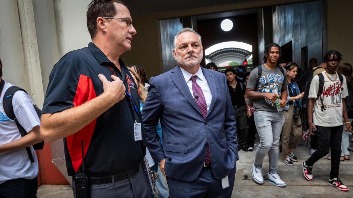 Coconut Creek, August 21, 2023 - Broward Schools Superintendent Peter Licata, center, talks to Monarch High School’s principal James Cecil, left, as students file into the building for the first day of school in Broward County.