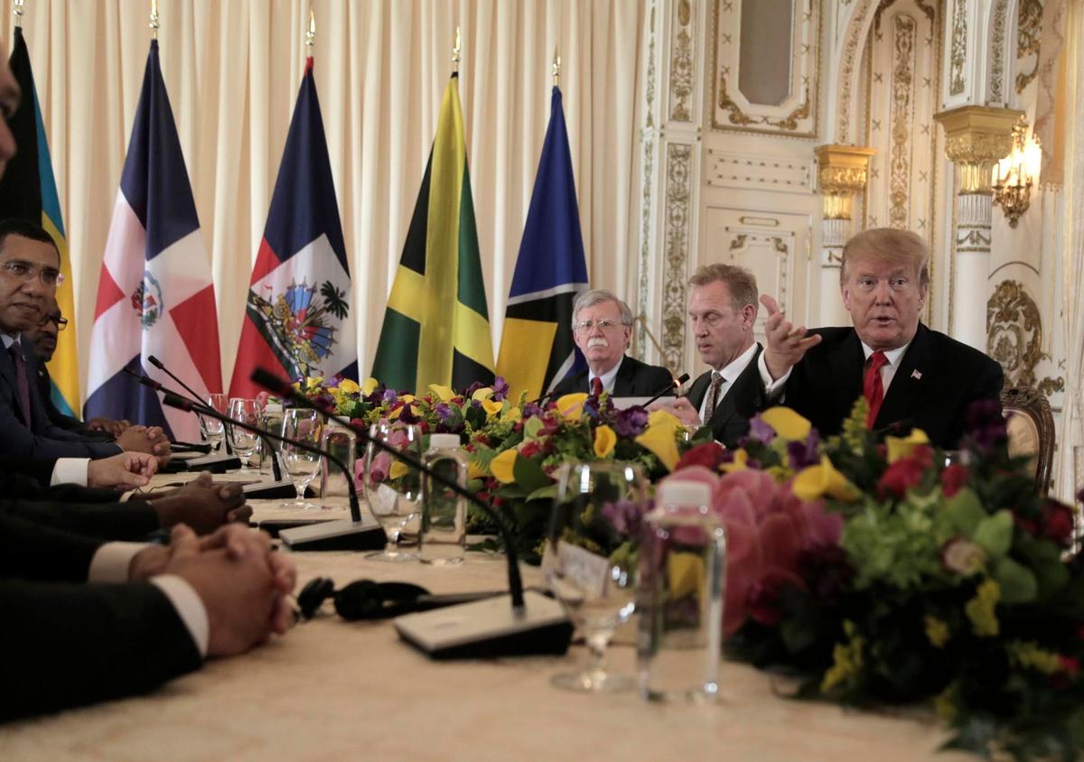President Donald Trump greets the media during a photo-op before the start of the meeting with Caricom leaders at Mar-a-Lago in Palm Beach, Florida, in March 2019.
