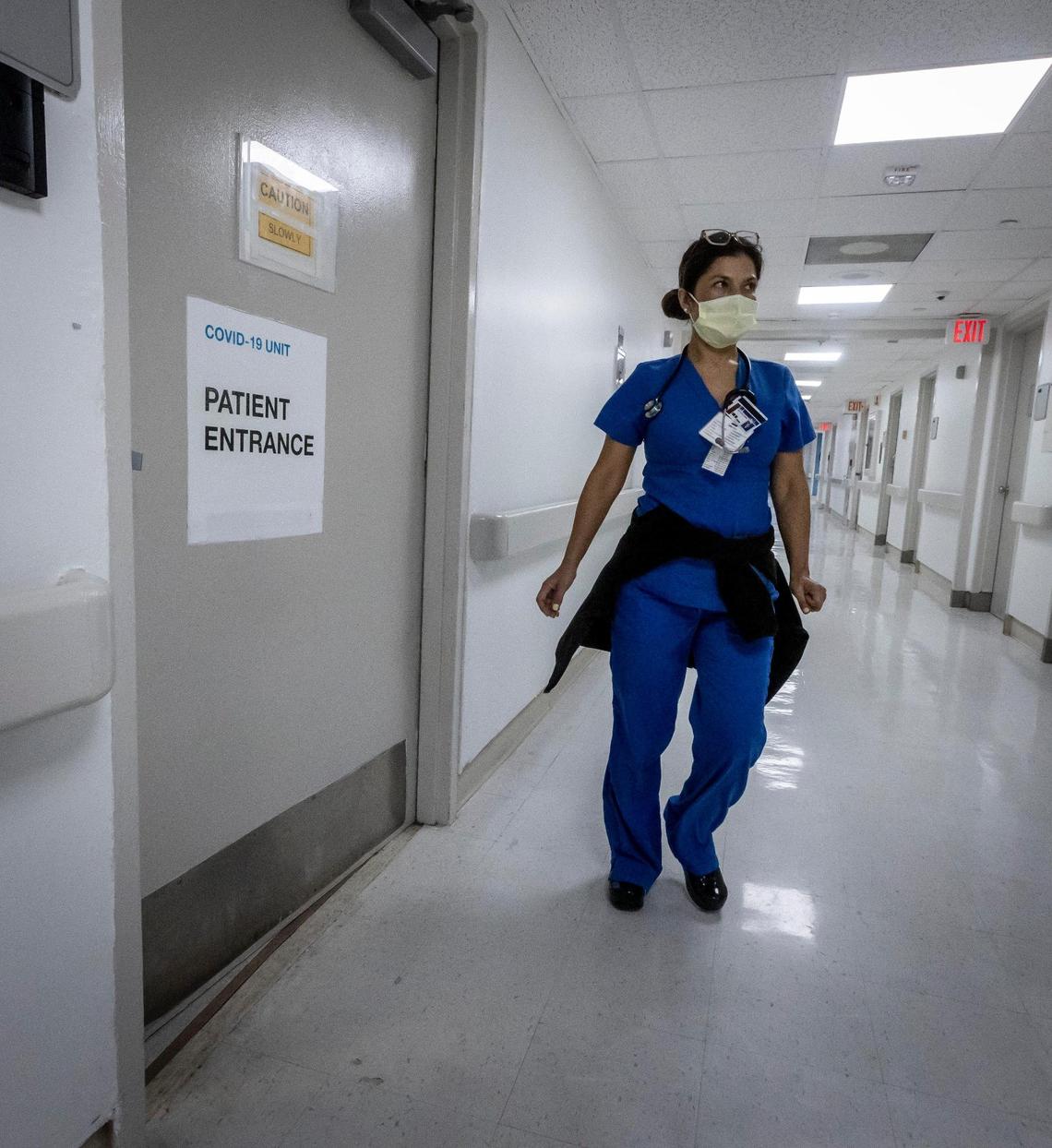 A nurse walks by the medical intensive care COVID unit at Jackson Memorial Hospital on July 23, 2021. COVID cases are surging in Florida and hospitalizations are rising, though the vast majority of patient admissions at Jackson and other area hospitals are unvaccinated younger people.