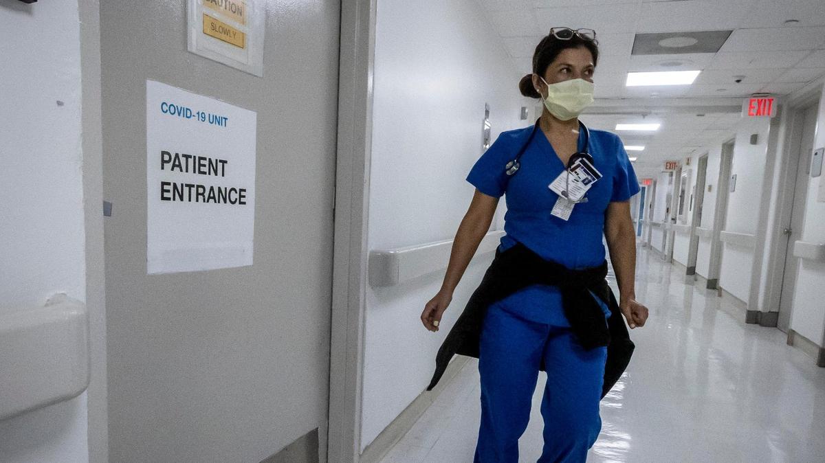 A nurse walks by an MICU COVID Unit at Jackson Memorial Hospital in July 2021.