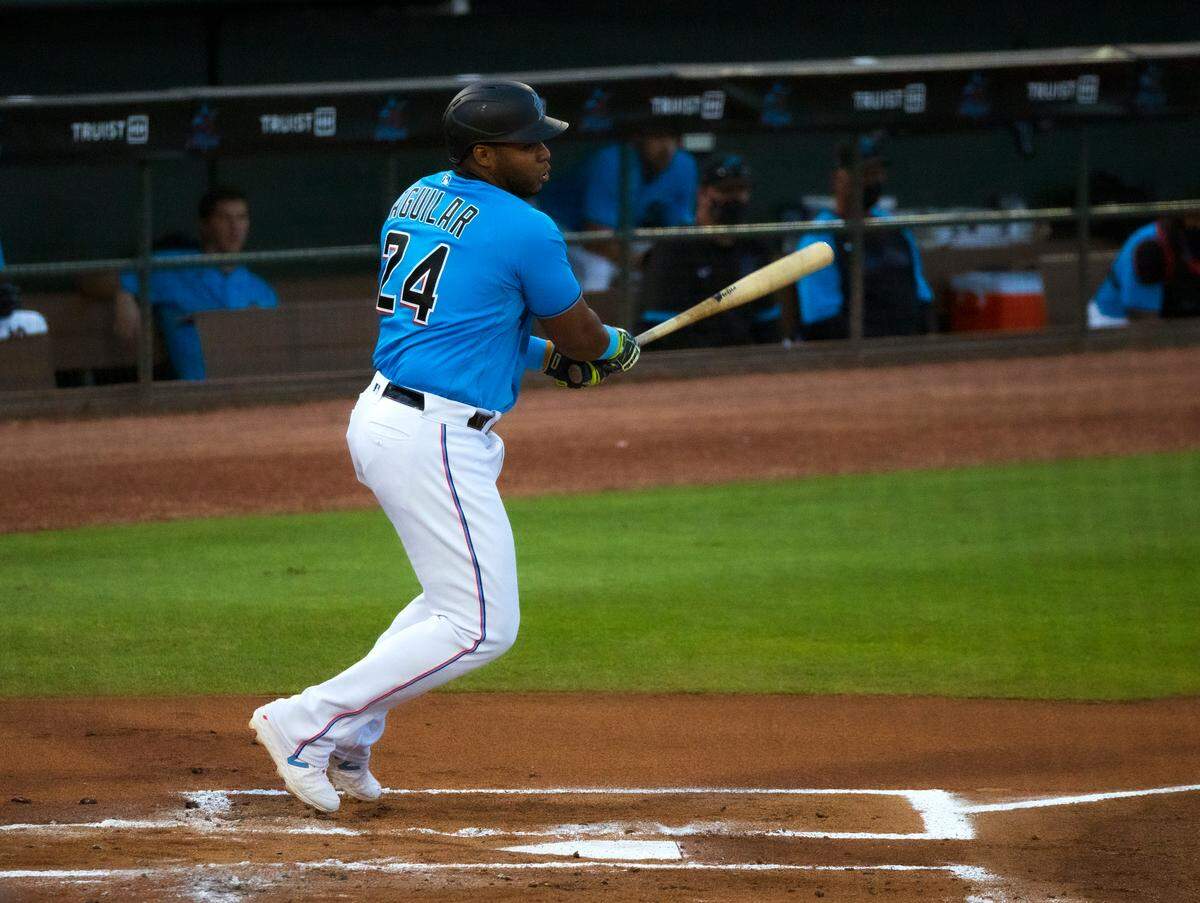 Miami Marlins first baseman Jesus Aguilar (24) bats against the Houston Astros during the first inning of the spring training baseball game at Roger Dean Chevrolet Stadium on Wednesday, March 10, 2021 in Jupiter, Florida.