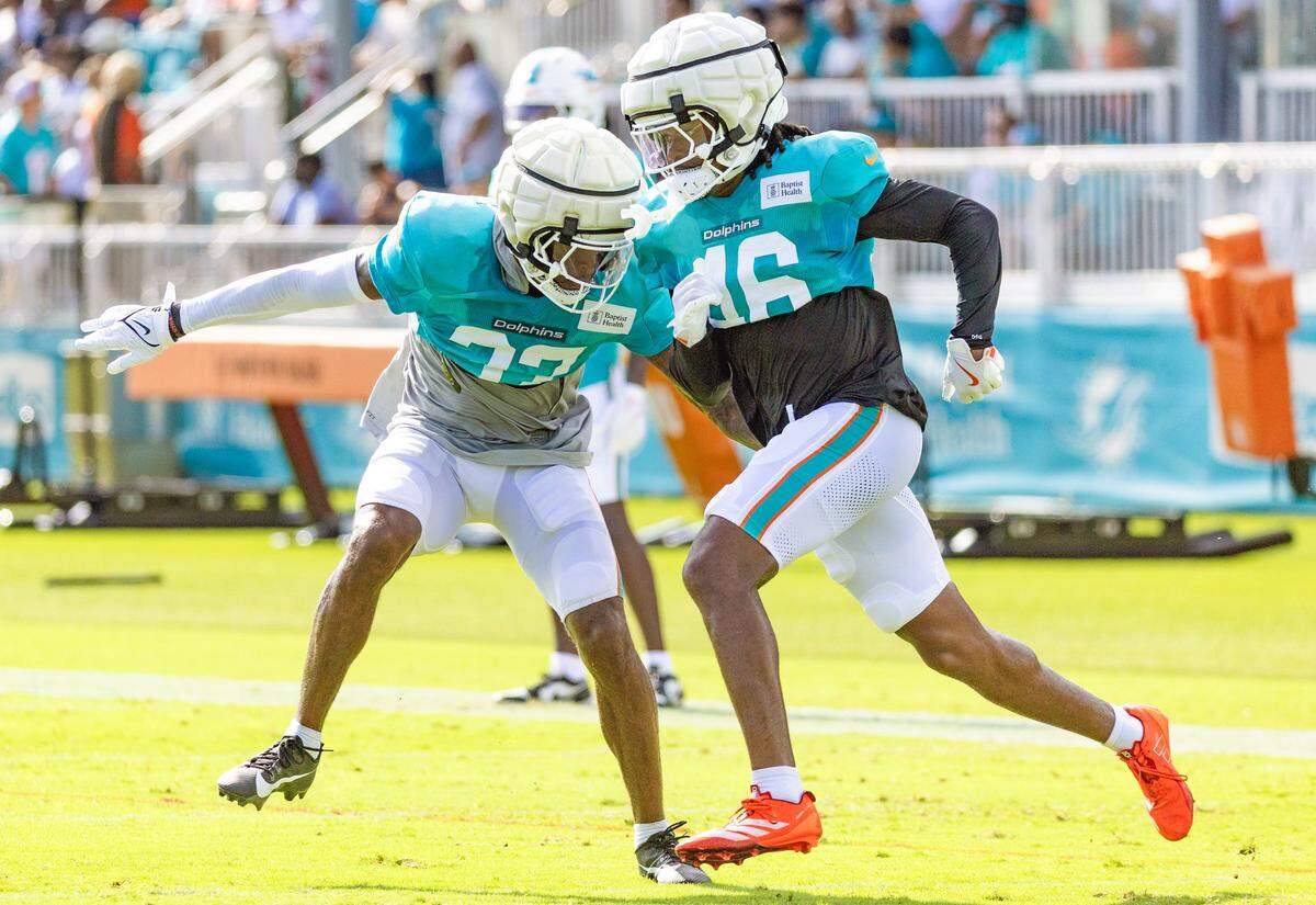 Miami Dolphins cornerback Isaiah Johnson (37) and Miami Dolphins cornerback Ethan Robinson (46) run through practice drills.