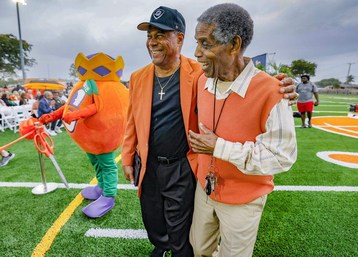 Nat Moore, special projects and alumni relations for the Miami Dolphins and Walt Frazier, seen left to right, arrive for the ribbon-cutting ceremony to open Orange Bowl Field at Walt Frazier Park on Tuesday, January 13, 2026 in Miami Gardens, Florida. The $2.3 million renovation includes a synthetic football field, an electronic scoreboard, and other refurbishments.