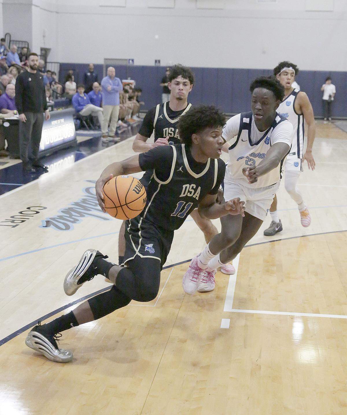 Divine Savior Academy Sharks Joost West (11) drives to the basket during the Region 4-2A semifinal boys basketball game against Riviera Prep Bulldogs on Thursday, February 19, 2026 at Riviera Prep School in Miami. Andrew Uloza / for Miami Herald
