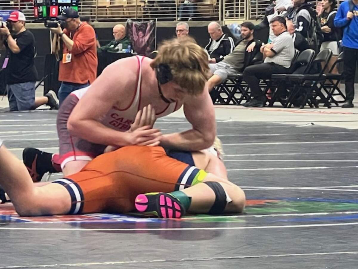 Cardinal Gibbons’ Michael Mocco holds down Mater Lakes’ Damian Soto during the Class 1A 215-pound weight class state championship bout on Saturday in Kissimmee, Fla.