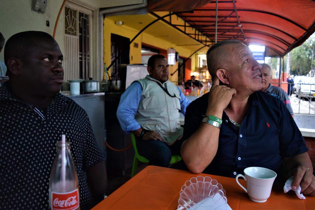 Moises López, left, and Alberto Pinto, background, watch over Nilson Liz Marin right, a community leader and advocate for Colombian farmers. Leaders like Marin are increasingly under attack; 155 were murdered last year in Colombia.