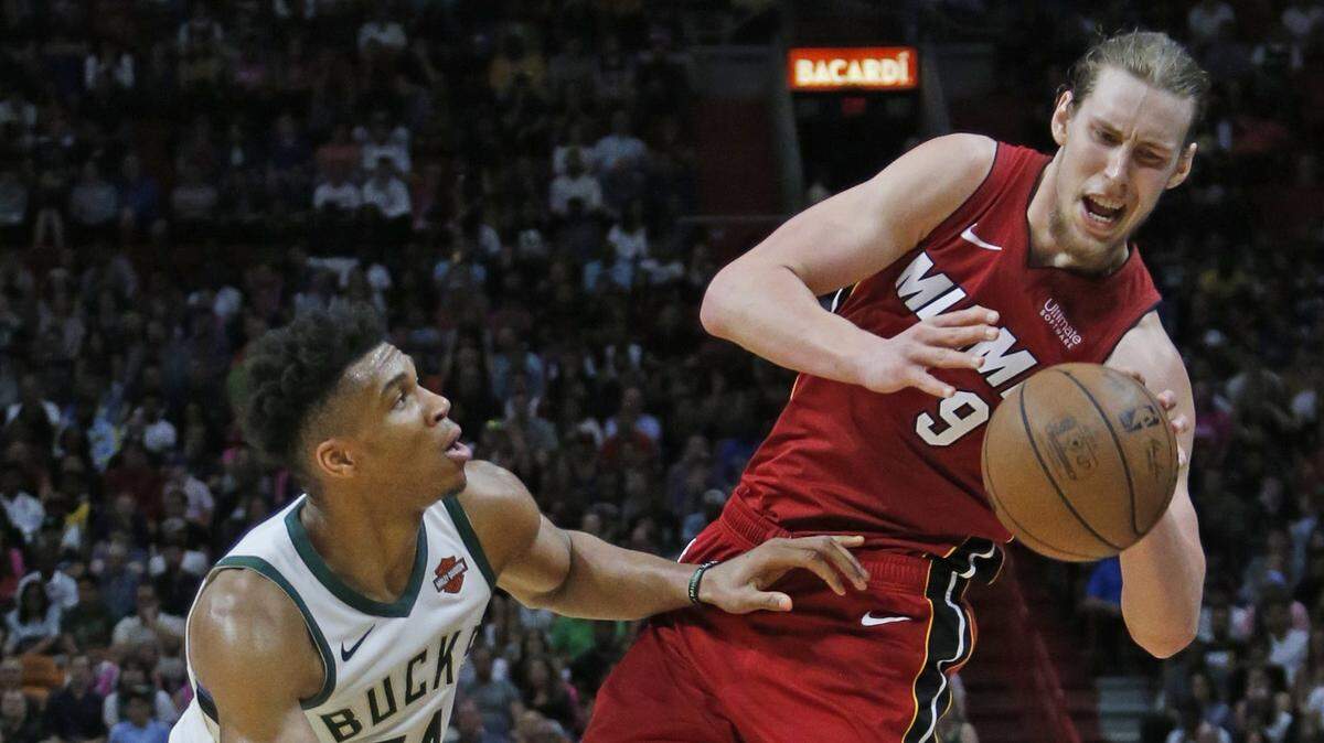 Miami Heat forward Kelly Olynyk (9) is fouled by Milwaukee Bucks forward Giannis Antetokounmpo (34) in the fourth quarter as the Miami Heat host the Milwaukee Bucks at the AmericanAirlines Arena on Friday, March 15, 2019.