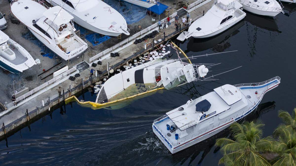 Aerial view of a 55-foot yacht that is leaking diesel and is partially submerged at Key Largo Harbor Marina on Wednesday, Dec. 10, 2025, in Key Largo, Fla.